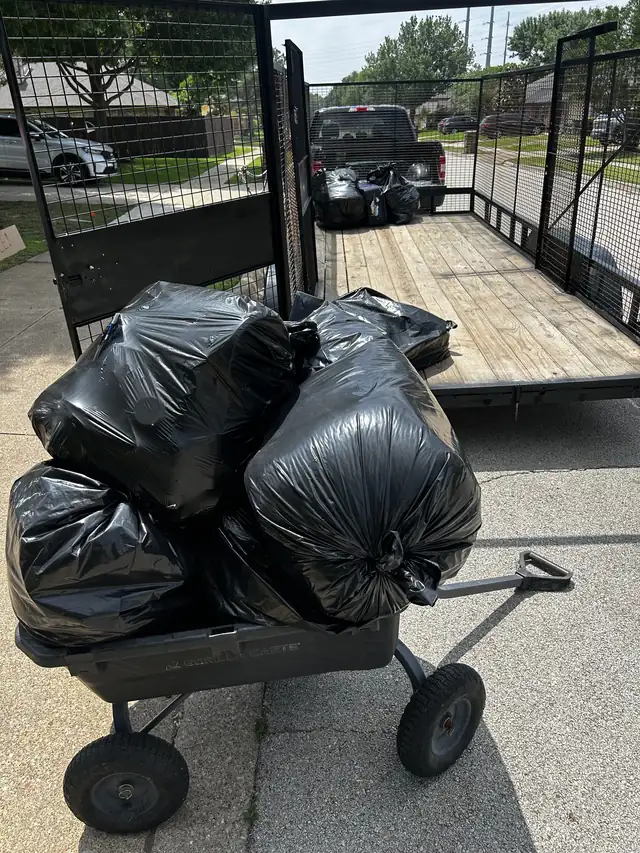 Bagged junk on a cart next to the Recourse trailer