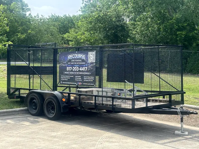 Recourse Junk Removal trailer with the company wrap and phone number