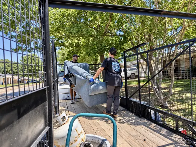 Recourse crew loading a couch onto the trailer