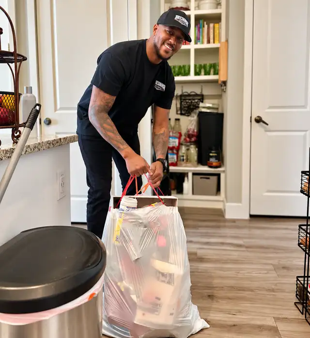 Recourse crew member bagging trash during a home cleanout