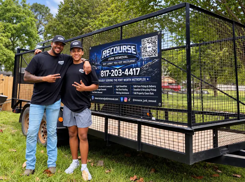 Recourse Junk Removal father-and-son team in front of their branded trailer