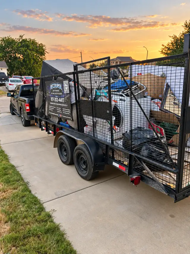 Fully loaded Recourse trailer parked at the curb at sunset